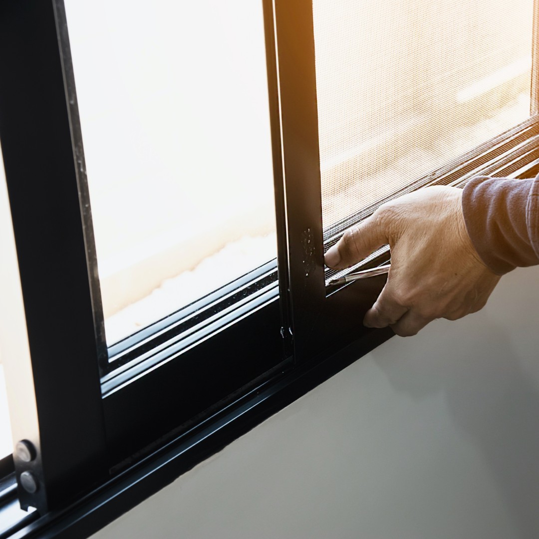 A person installing a window.